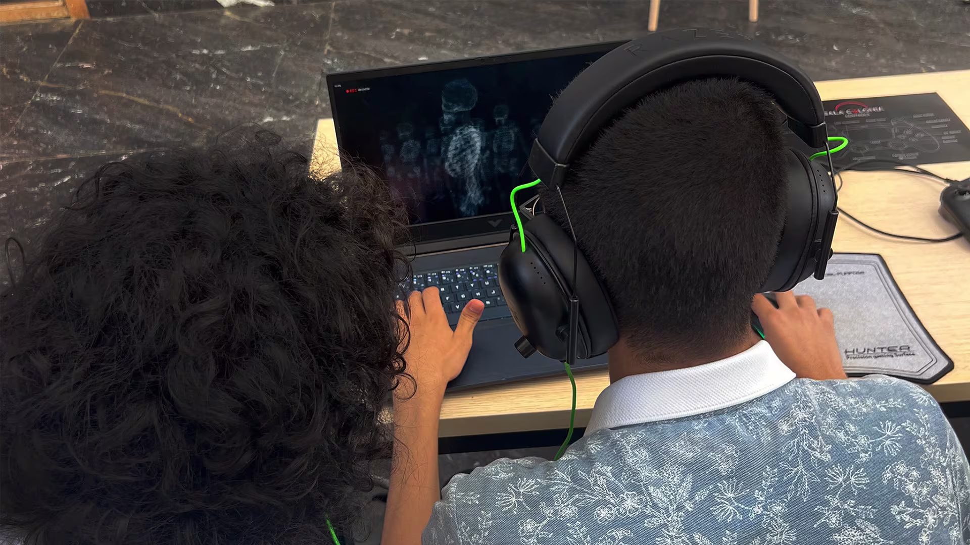 Playtester trying an early Lost In SalaColonia build on a laptop